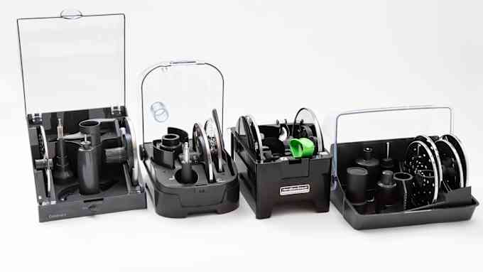 four storage cases filled with different assortments of blades and attachments that come with different food processors
